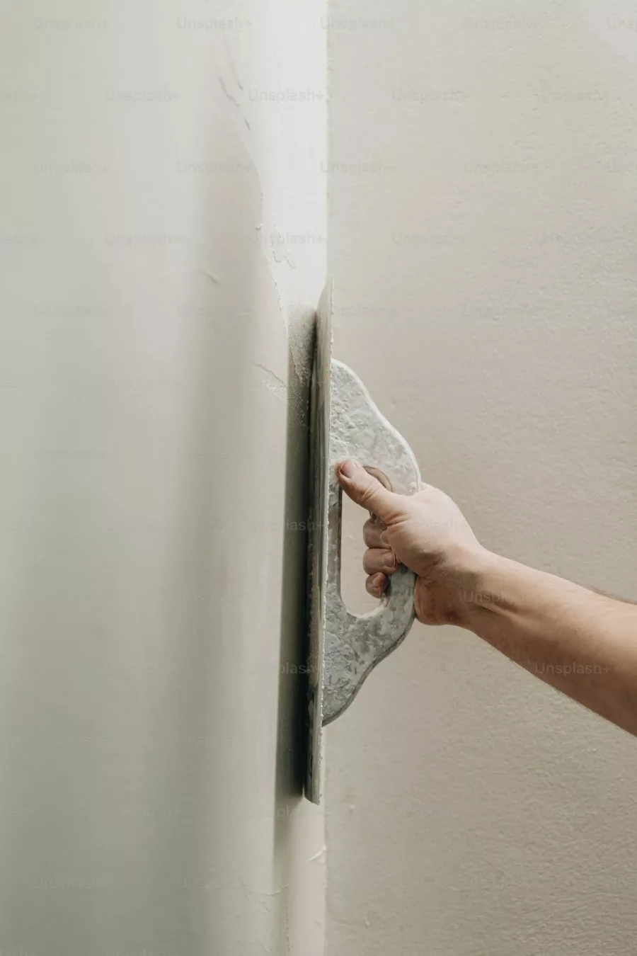 Plasterer finishing a wall